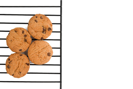 Chocolate chip cookies on cooling rack isolated on white background. Top view.