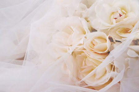 Wedding background with white roses and veil. Close up.
