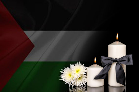 Palestine flag, candles and white flower on black background.の写真素材