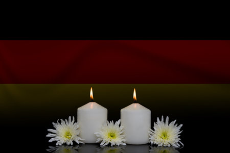 German flag with candles on black background. 3D illustration.の写真素材