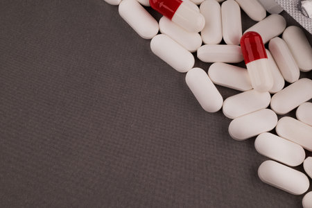 Close up of pills and capsules on grey background with copy space.の写真素材