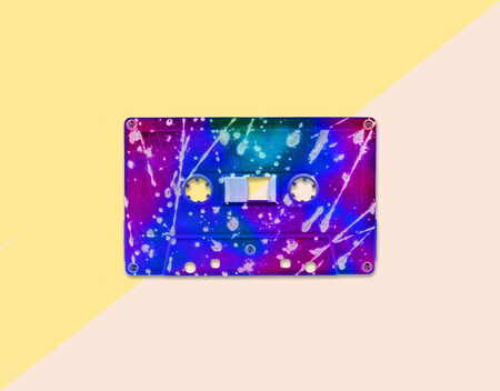 Vintage neon audio cassette tape on pastel background. Trendy pop art style.の写真素材
