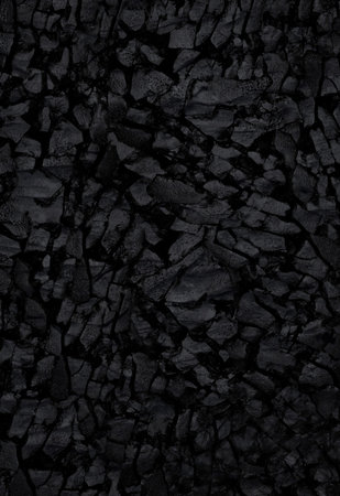Natural black activated charcoal texture for backgrounds. Top view.