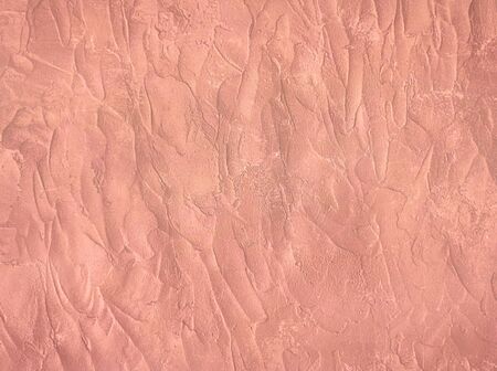 Concrete texture painted in trendy rose gold colour. Cement stucco wall background. の写真素材