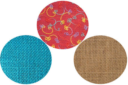 Assorted hessian samples - natural, dyed and embroideed - isolated on whiteの写真素材