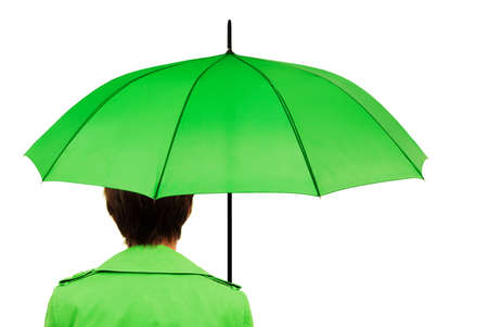 Woman in green coat with green umbrellaの写真素材