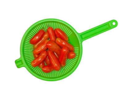 Freshly picked plum (San Marzano) tomatoes in colander. Isolated.の写真素材