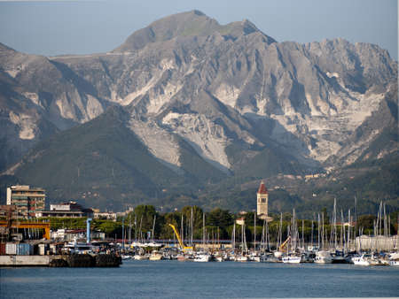 Marina di Carrara  from off-shore with marble mountainsの写真素材