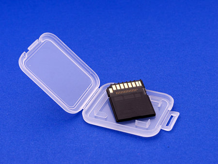 SDHC card in plastic holder, over blue textured background