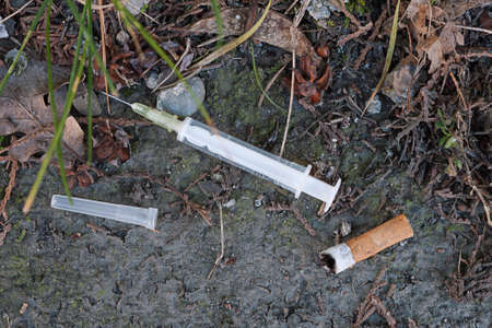 Discarded syringe in street gutterの写真素材