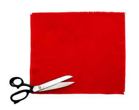 Dressmaking or tailor scissors with red fabric swatchの写真素材