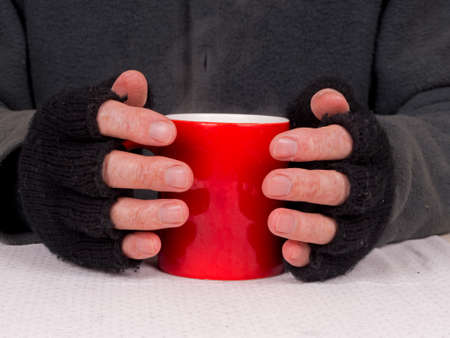 Poverty - poor man with steaming cup of soup or teaの写真素材