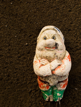 Very old garden gnome on fine tilth - backgroundの写真素材