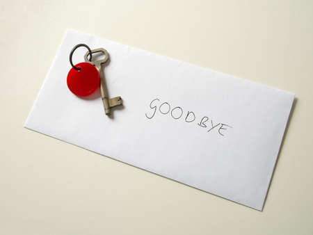 Leaving you concept  Key and envelope on table の写真素材