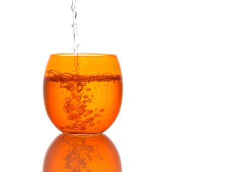 Cool clear water pouring into bright glassの写真素材