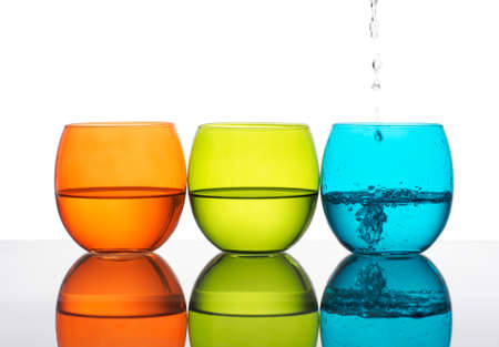 Beautiful bright glasses of water, one being poured の写真素材