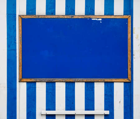Horizontal old notice board, holiday resort style, blue and white stripesの写真素材