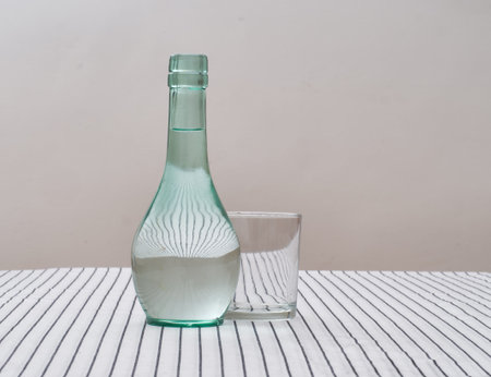 Carafe of water to drink with glass on table. Interesting optical effect.の写真素材