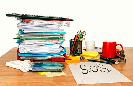 Office stress SOS. With paperwork, painkillers and coffee mug!の写真素材