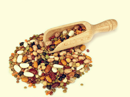 Beans, pulses, lentil with scoop on cream background for retro look