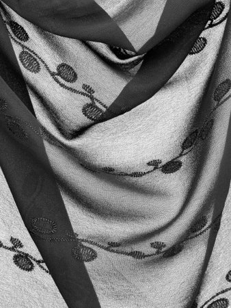 Shades of grey, gray. Light fabric draped. With embroidery.