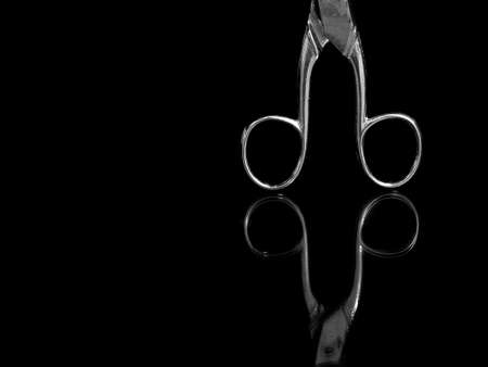 Old kitchen scissors reflected with black.の写真素材