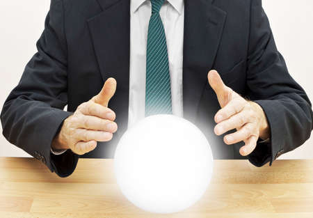 Strategic planning businessman. Or accountant doing budget with crystal ball.の写真素材
