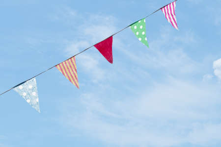 Assorted fabrics bunting against blue sky.の写真素材