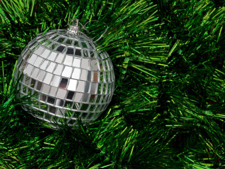 Mirror ball Christmas tree decoration on green tinselの写真素材