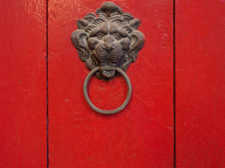 Really bright red door with old lion knocker!の写真素材