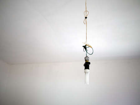 Bad electrical wiring, danger. With modern light bulb.の写真素材