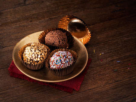 Irresistible! Tempting chocolate truffles - one already eaten.の写真素材