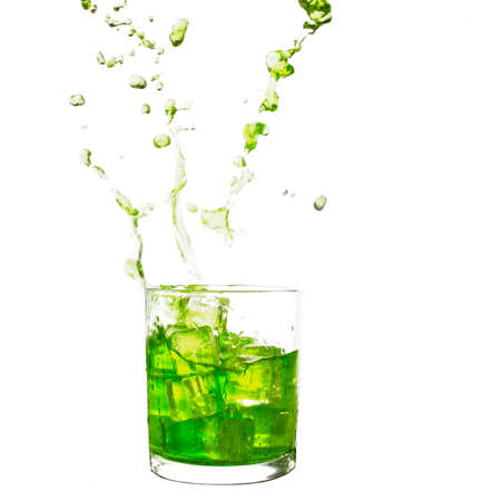Green splash drink. Summer refreshment. White background.の写真素材