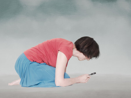 Mature lady in skirt with magnifying glass. Grey background.