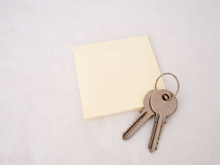 Keys on note pad. Blank for your message.の写真素材