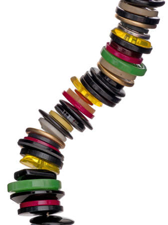 Old buttons kept on string, isolated on white background. Habderdashery, home sewing element.の写真素材