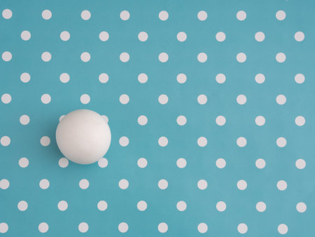 Large white marble ball amongst small dots on turquoise. Different, unique or just trying to adapt,...