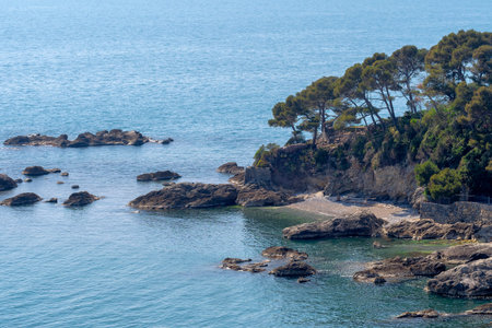 Deserted small beach in idyllic mediterranean cove, blue sea and sand. Peaceful and calm. Getaway secluded vacation.の写真素材