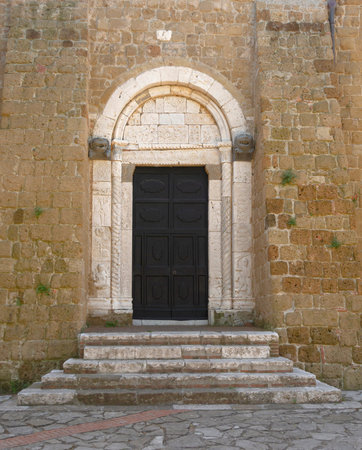 SOVANA, TUSCANY, ITALY - JUNE 16, 2019 - Entrance to the Concattedrale dei Santi Pietro e Paolo aka...