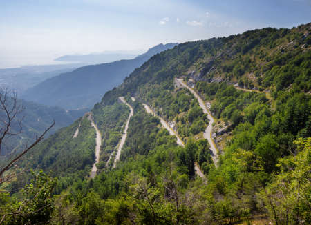 View of zigzag mountain road with hairpin bends in the Apuan Alps, Alpi Apuane, near the Vestito Pass. Above Massa Carrara, Italy. Less travelled.の写真素材