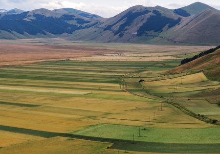Castelluccio di Norcia, in Umbria, Italy. Fields and hills, sunny day. Colourful landscape.