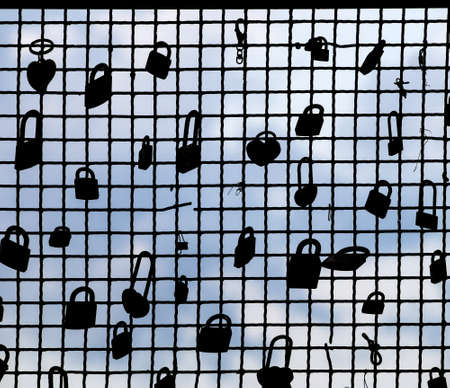 Padlocks, love symbols, silhouetted against blue sky. Cinque Terre, the Five Lands, Liguria, Italy.の写真素材