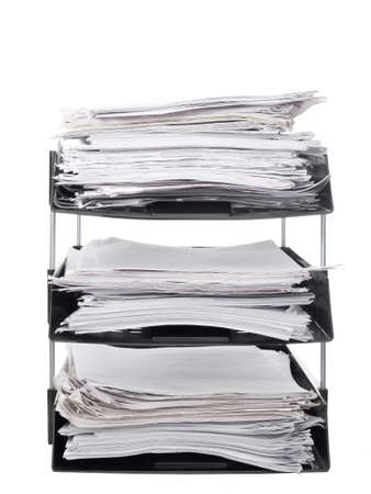 Office paper filing trays isolated on white background. Lots of paperwork, work, bureaucracy.の写真素材