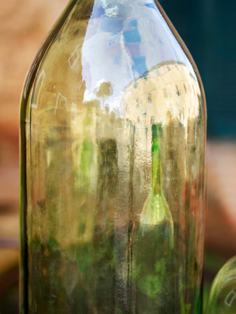 Reflections of Bolgheri in a wine bottle. Village in Tuscany, Italy.