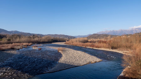 Lunigiana winter landscape view near Aulla. Magra River and mountains behind.