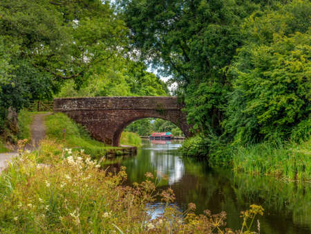 Manley Bridge The Grand Western Canal, Tiverton, Devon. Narrow Boat beyond.の写真素材