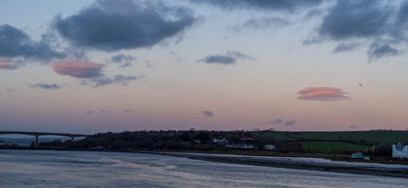 Pink sunset evening over East the Water and Torridge Estuary in North Devon, England.