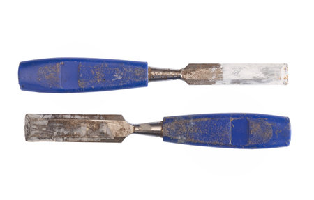 Two old blue chisels, plastic handles, also used as paint stirers. Isolated on white background.