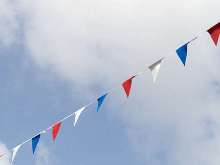Photo of red white and blue triangular bunting on sky background. Queens Jubilee 2022.の写真素材