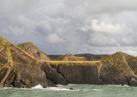 Sunny period as late evening light falls on the cliffs near Hartland Quay, North Devon, Uk.